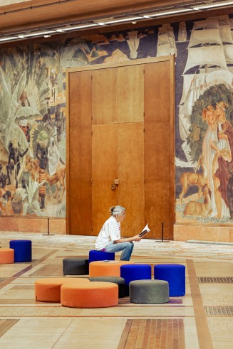 Une personne qui consulte le livret sur les fresques du Forum