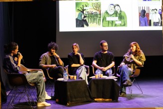 5 intervenants assis sur la scène de l'auditorium